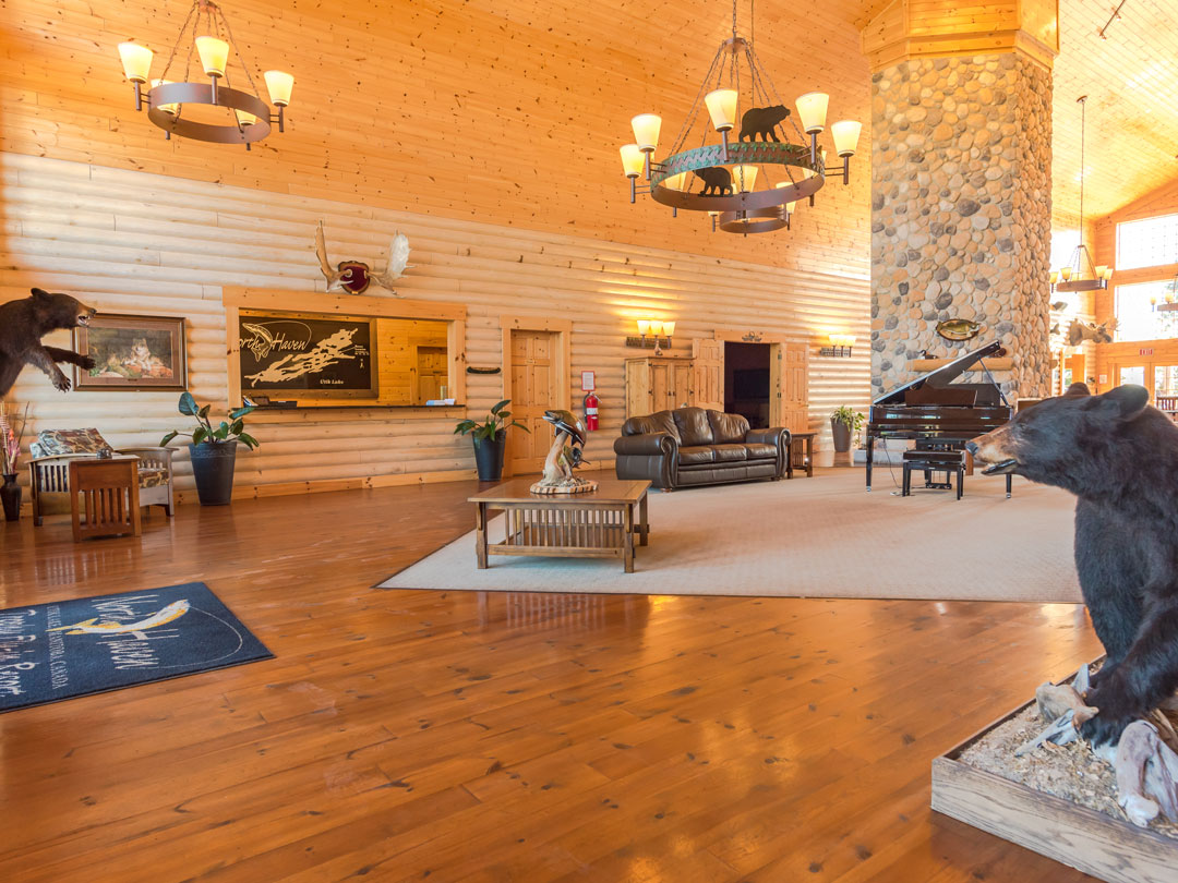 Lounge with Piano & Fireplace at North Haven Resort on Utik Lake, MB