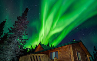 winter cabins at North Haven Resort featuring the Northern Lights